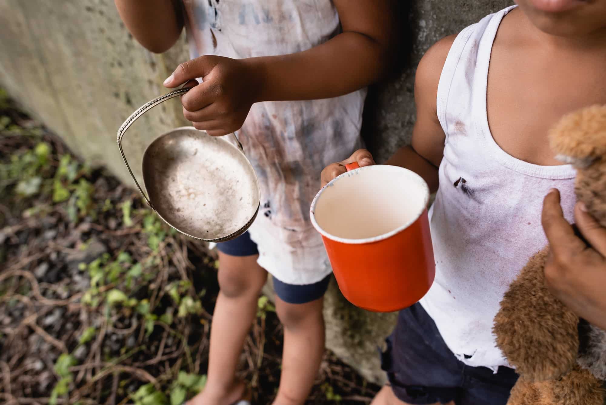 cropped-view-of-homeless-african-american-kids-holding-cup-and-metal-plate-while-begging-alms-on.jpg